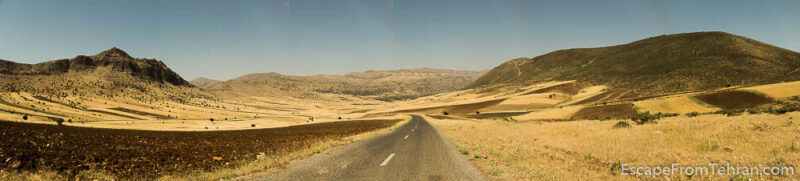 The flat areas along the road are covered with unirrigated wheat fields and herds of sheep and goats.
