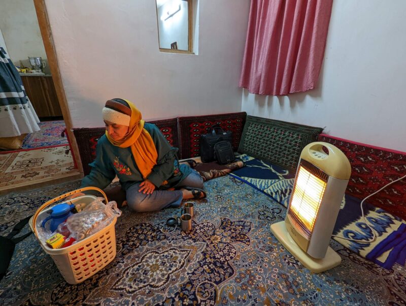 Saeideh on the floor making tea in the suite for rent in tiny village of Lāsem, Dashte Gole-Zard area, a refuge from the madness of Tehran, Iran. Copyright Ali Torkzadeh, EscapefromTehran.com